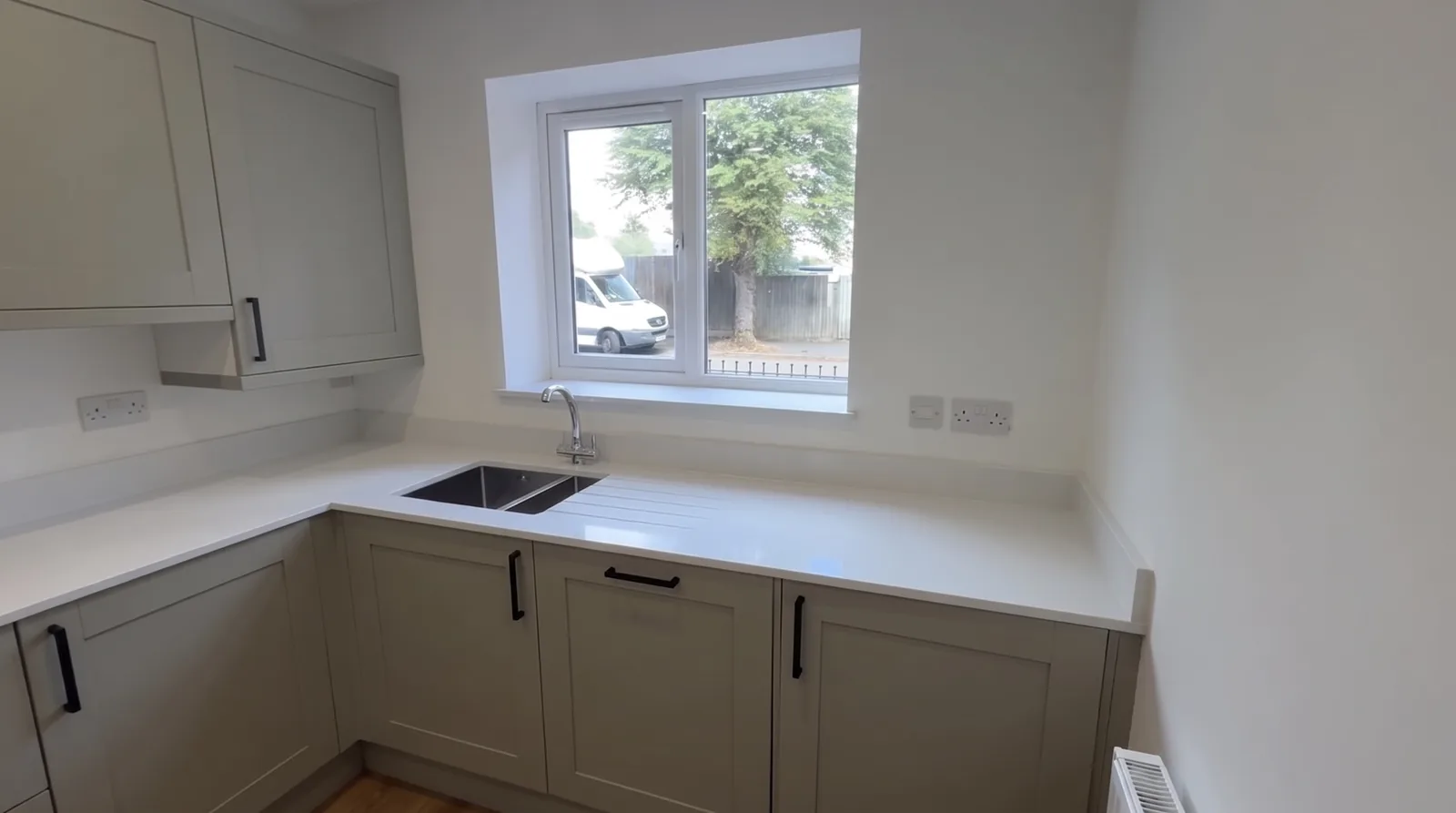 Stoke House — Fitted kitchen with a white worktop and a window