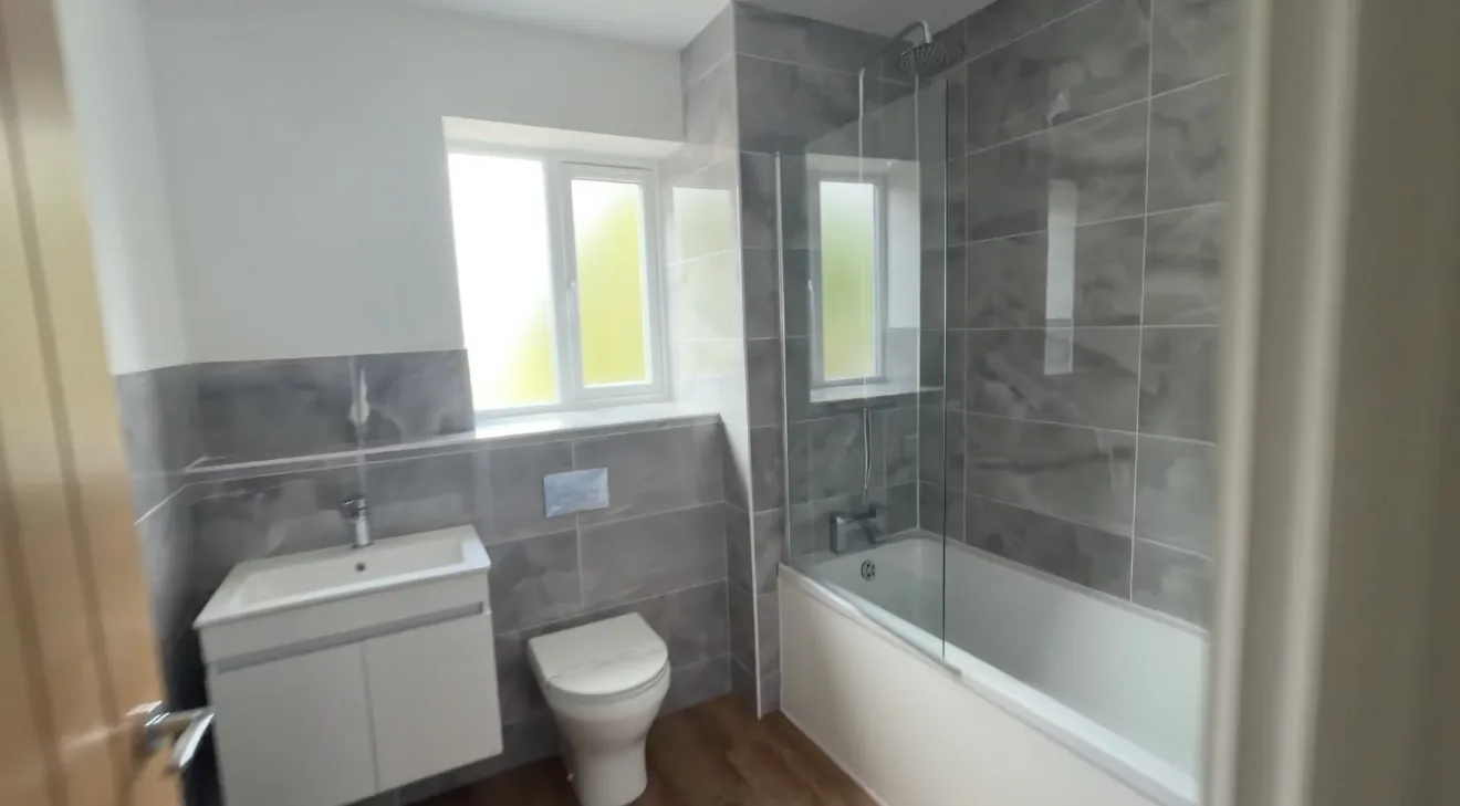 Stoke House — Family bathroom with a bath and shower screen