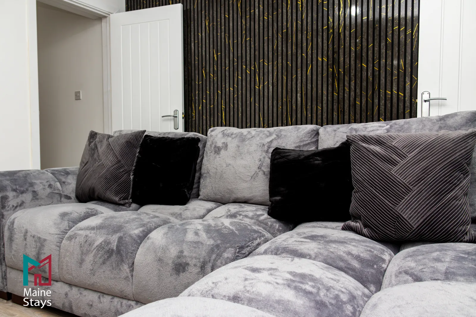 The Dudley Lounge — Grey velvet sofa with cushions in the living room