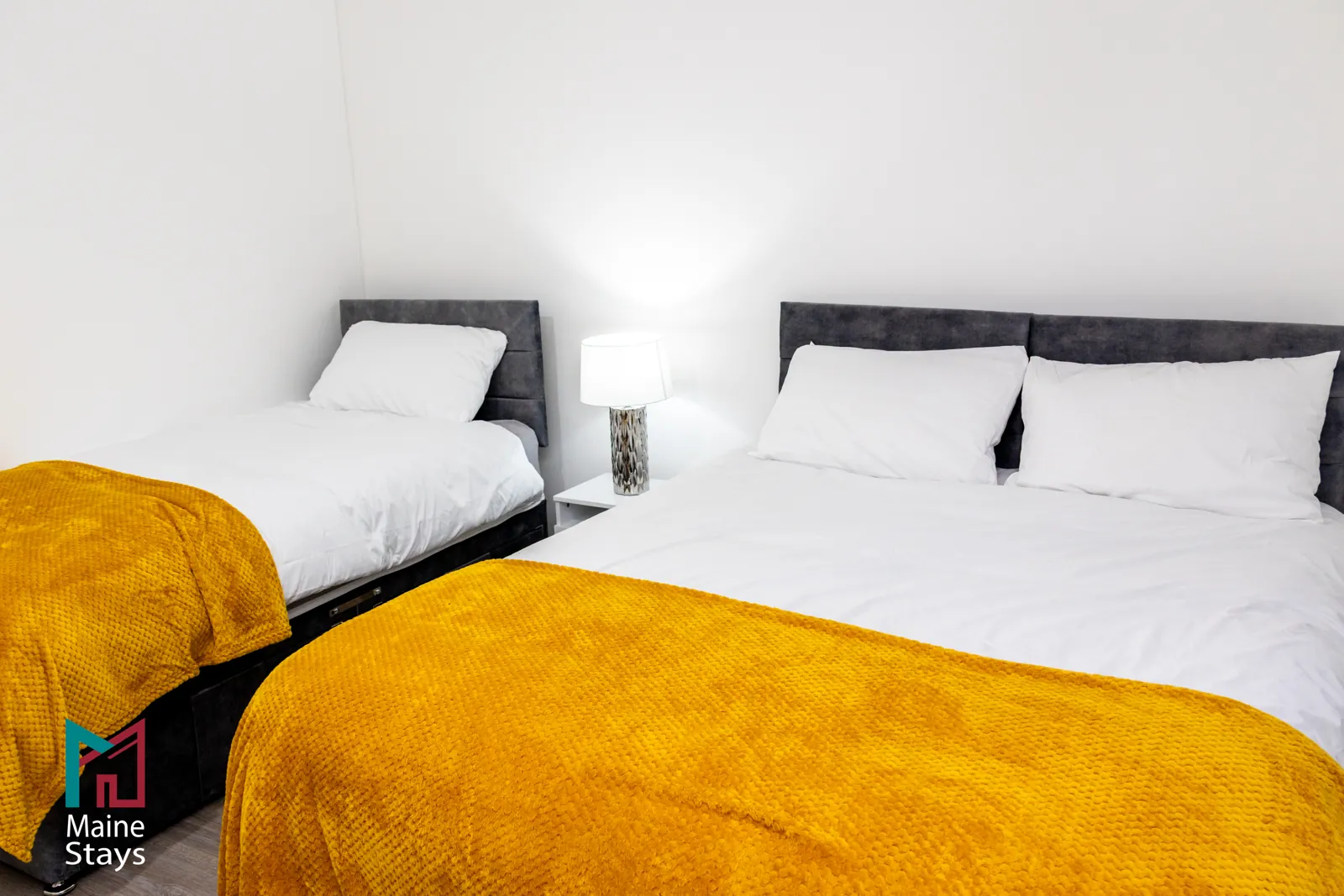 The Dudley Lounge — Double and single beds with mustard throws