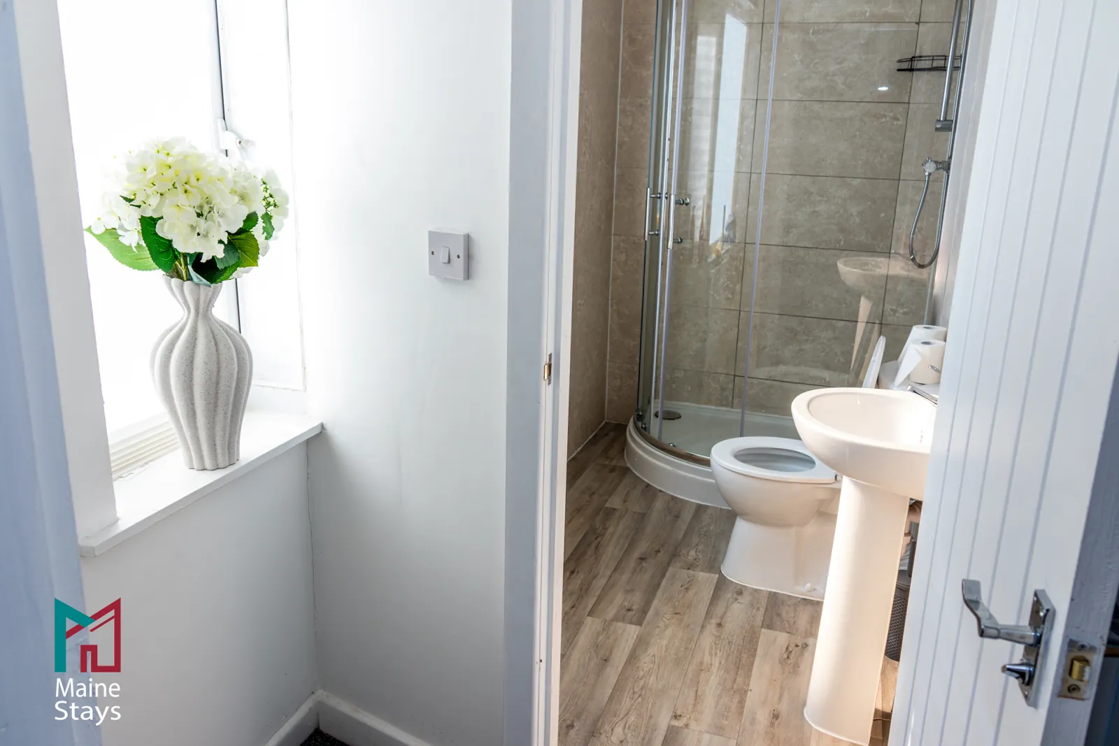 The Dudley Lounge — Shower room with corner shower, basin and toilet