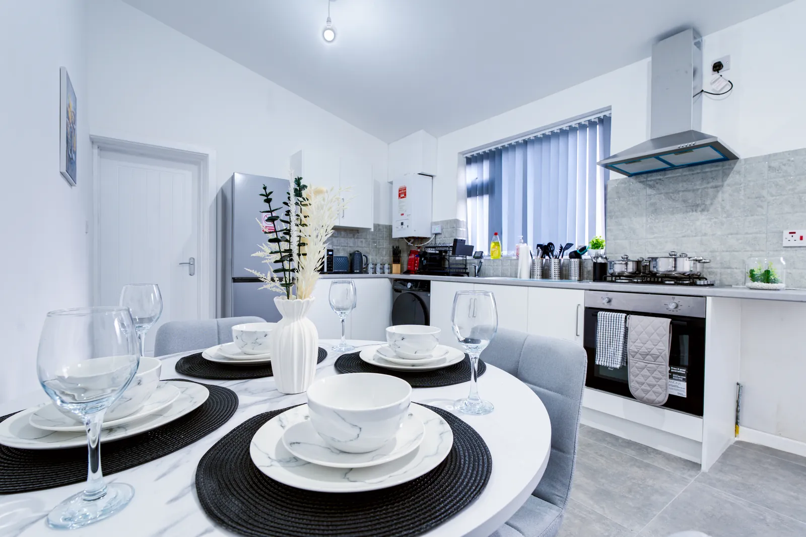 The Merry Hill Lounge: dining table laid for four with the kitchen behind